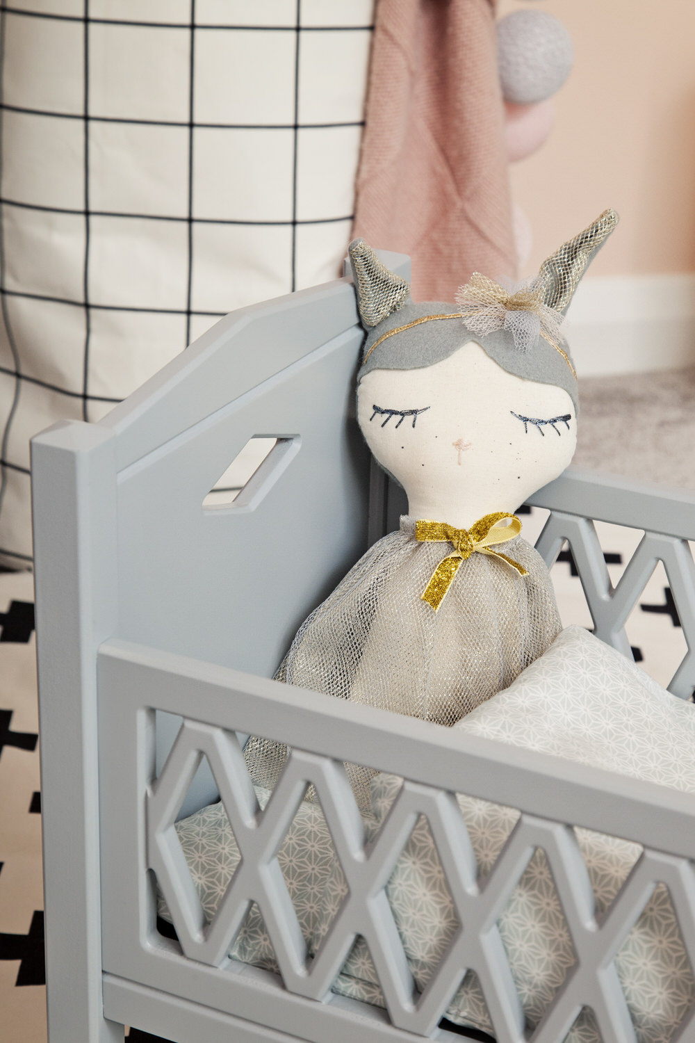 Grey Dolls Cot | A pastel and monochrome nursery for a little girl with details from The Modern Nursery.