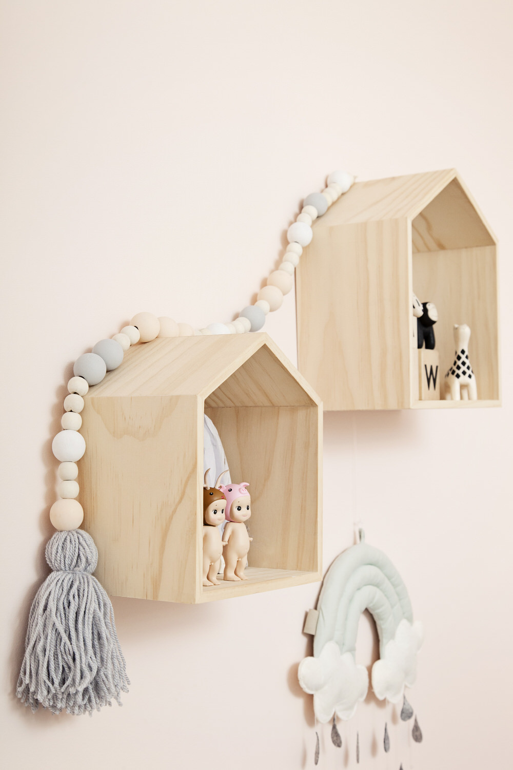 Wooden House Shelves | A pastel and monochrome nursery for a little girl with details from The Modern Nursery.