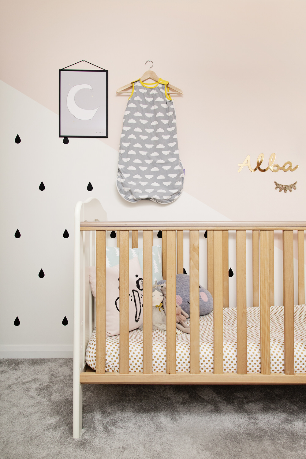 Wooden Cot | Monochrome Wall Stickers | A pastel and monochrome nursery for a little girl with details from The Modern Nursery.