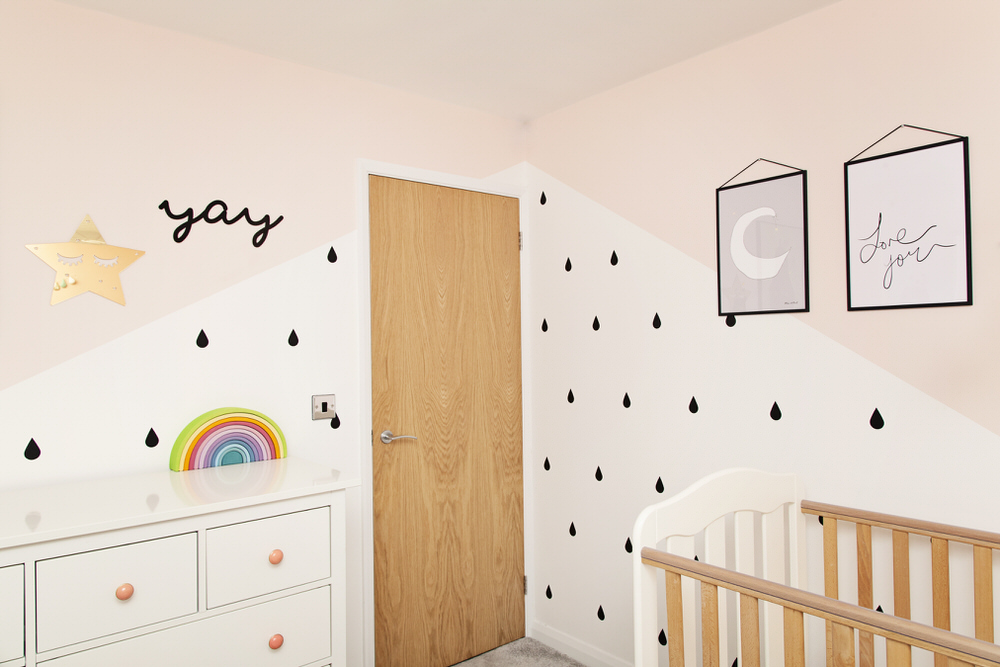 Monochrome wall stickers | Yay Signs | Rainbow toy | A pastel and monochrome nursery for a little girl with details from The Modern Nursery.