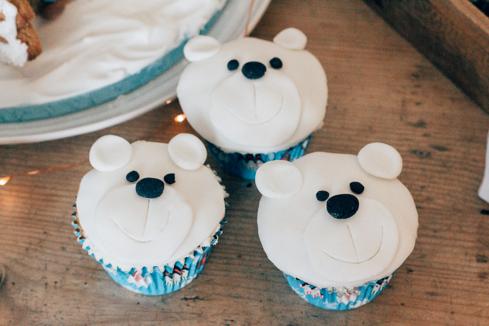Polar bear Christmas cupcakes covered with fondant icing and details