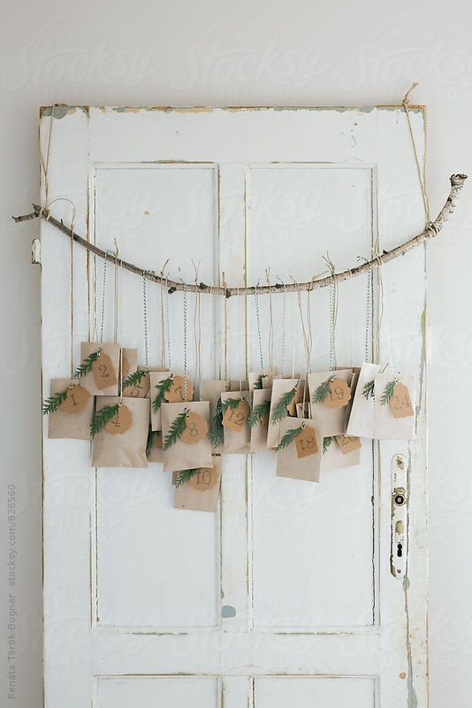 Homemade Advent Calendars For Kids. Hanging paper bags from branch with brown paper and string.