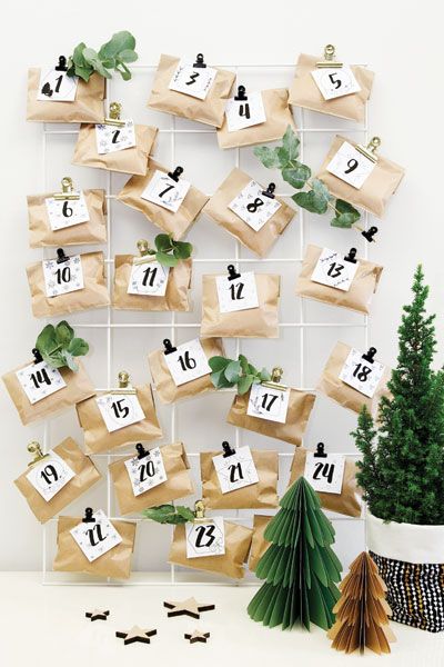 Homemade Advent Calendars For Kids. Mini brown paper parcels and monochrome labels clipped to wire notice board.
