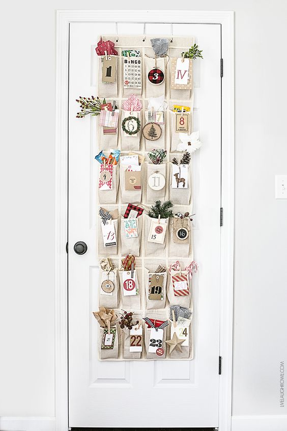 Homemade Advent Calendars For Kids. Woodland inspired advent calendar hanging from white wooden door.