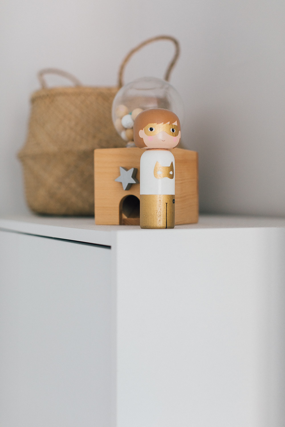 Wooden toys | A modern neutral millennial pink bedroom for children with handmade furniture, personalised artwork and statement lighting.