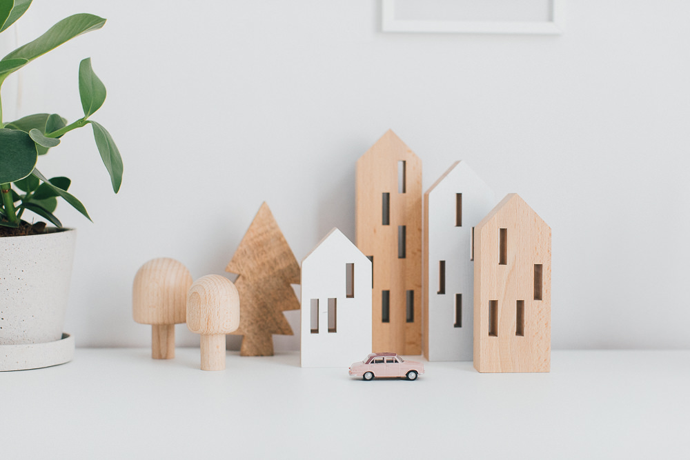 Wooden House Toys | Wooden Desk Accessories | A Frame Desk | Neutral Desk Accessories | White Desk Chair | Statement Wall Light | A modern neutral millennial pink bedroom for children with handmade furniture, personalised artwork and statement lighting