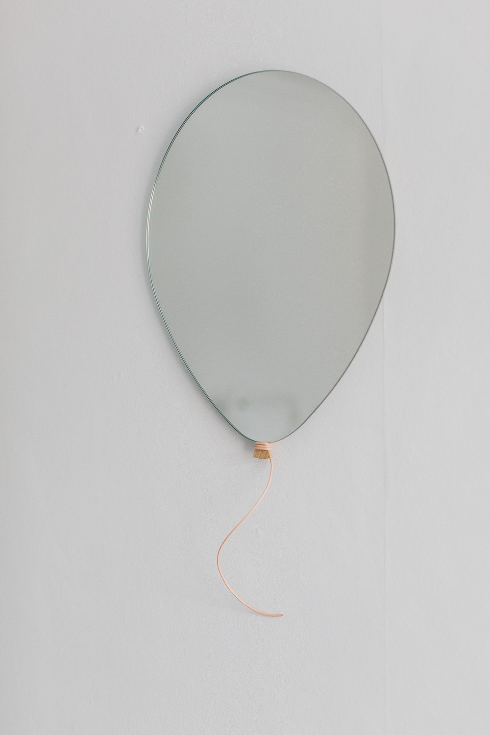Balloon wall mirror | A modern neutral millennial pink bedroom for children with handmade furniture, personalised artwork and statement lighting