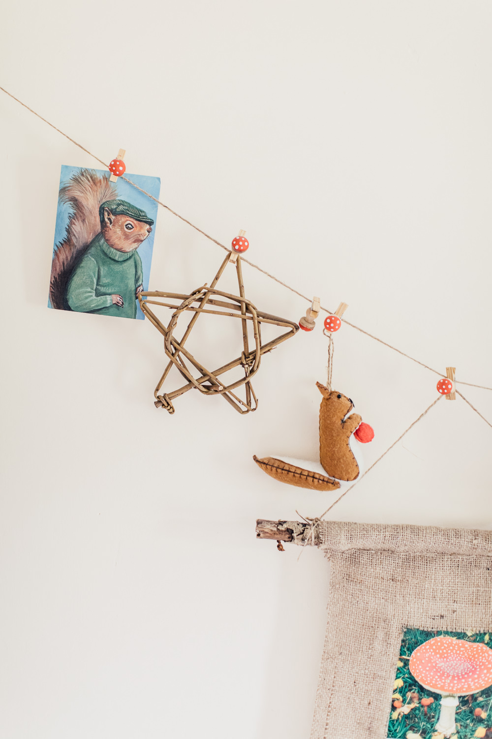 Woodland decor | Bright toys and wall decor in a woodland inspired children's bedroom in a rented property with homemade decor and details.