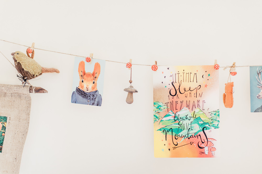 Gallery wall in a woodland inspired children's bedroom in a rented property with homemade decor and details.