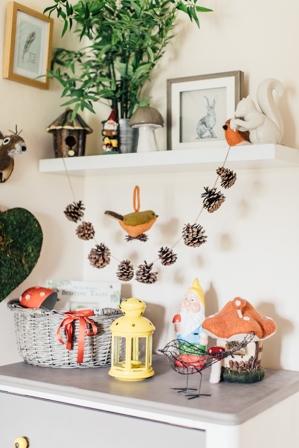 Hanging pine cones garland | Pine cone garland in a woodland inspired children's bedroom in a rented property with homemade decor and details.