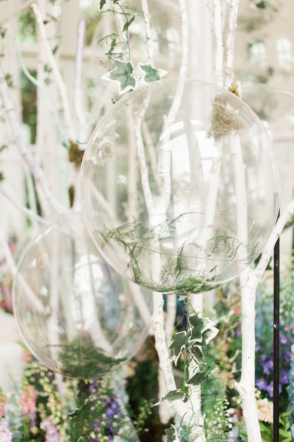 Clear helium balloons with floral tails | Party Decor | A Midsummer nights dream inspired children's birthday party with stunning floral, fairy entertainment, crafts and a picnic. Photos by Kate Nielen.