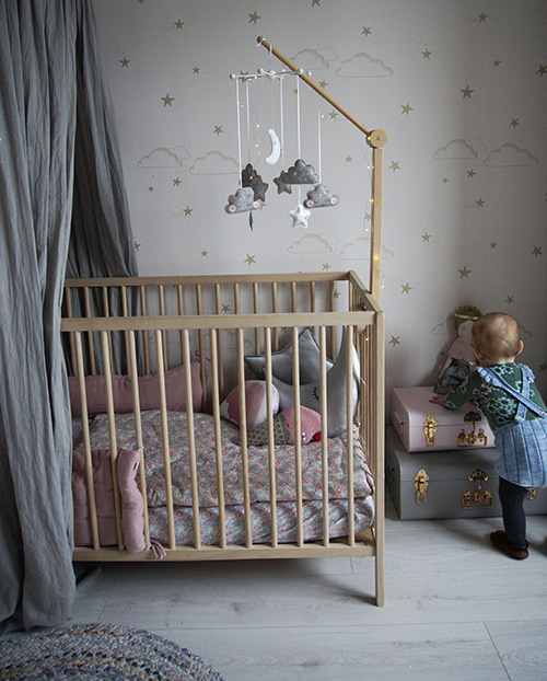 Pink and grey nursery with Ikea cot and wallpaper from Hibou Home